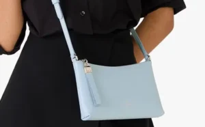 A Person Wearing Kate Spade Outlet Sadie Small Crossbody