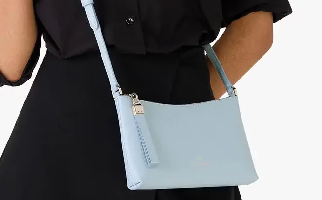 A Person Wearing Kate Spade Outlet Sadie Small Crossbody