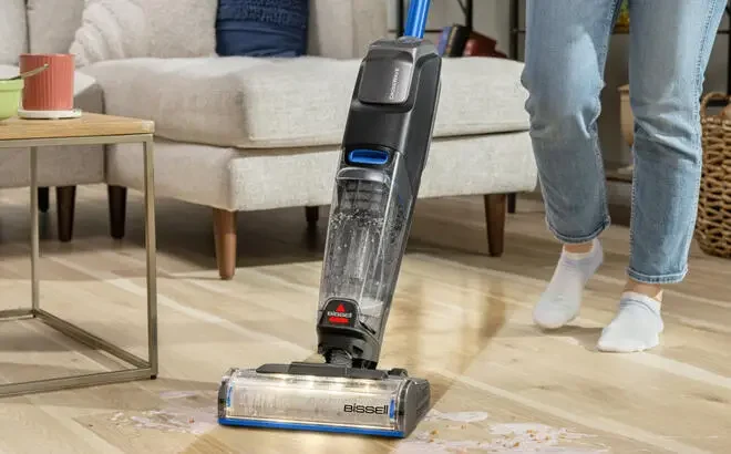 A Person using a Bissell CrossWave OmniFind Multi Surface Floor Cleaner